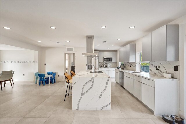 kitchen featuring a center island, sink, stainless steel appliances, decorative backsplash, and island range hood