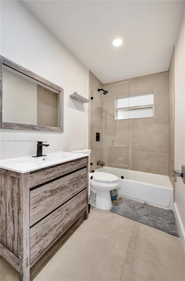 full bathroom with vanity, toilet, and tiled shower / bath