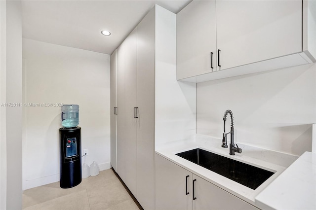 bar with sink and white cabinets