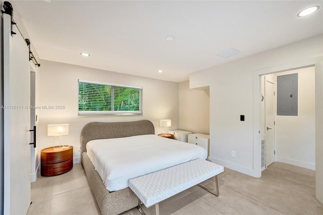 bedroom featuring a barn door and electric panel