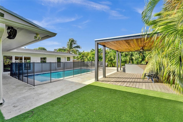 view of pool with a yard, a patio, and ceiling fan