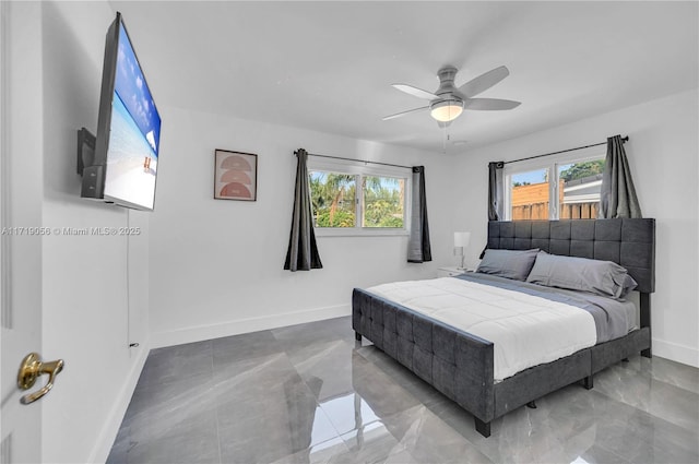 bedroom with multiple windows and ceiling fan