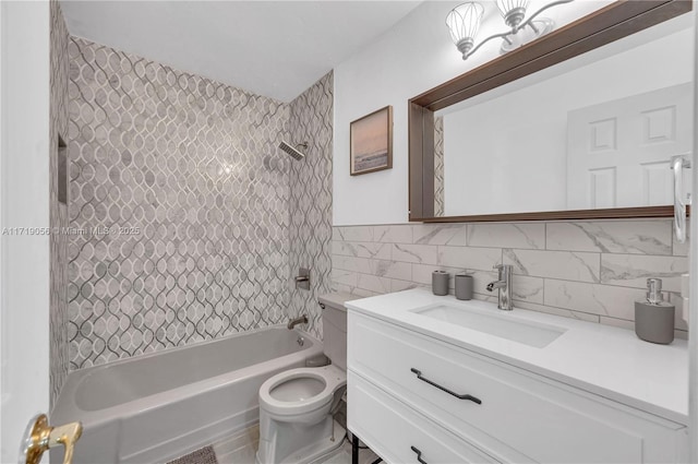 full bathroom with vanity, tiled shower / bath, toilet, tile walls, and tasteful backsplash