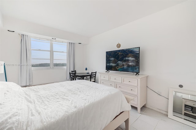 bedroom with light tile patterned floors