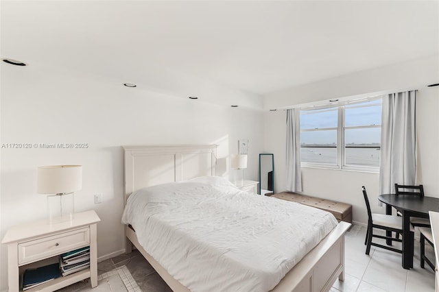 bedroom with light tile patterned floors