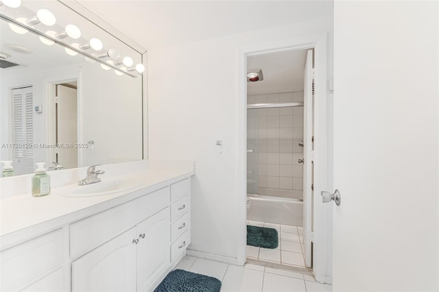 bathroom featuring tile patterned flooring, vanity, and combined bath / shower with glass door