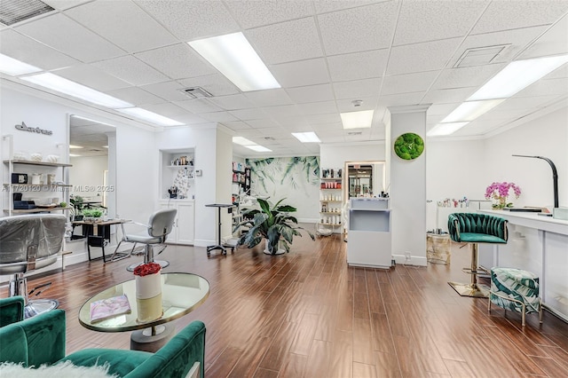 living room with a paneled ceiling and wood-type flooring