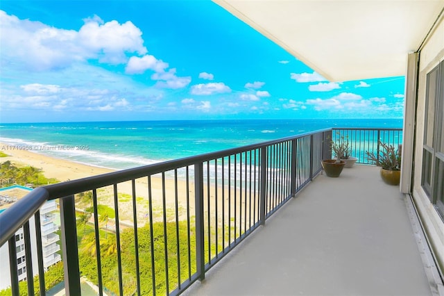 balcony featuring a water view and a view of the beach