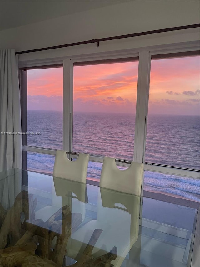 dining area featuring a beach view and a water view