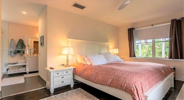 bedroom with baseboards, visible vents, and dark wood-type flooring