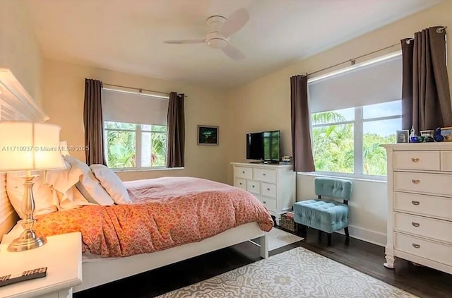 bedroom with a ceiling fan, baseboards, and wood finished floors