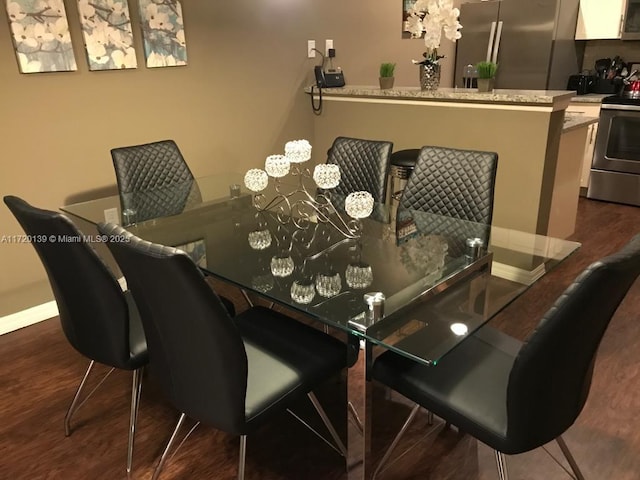 dining area with dark hardwood / wood-style floors