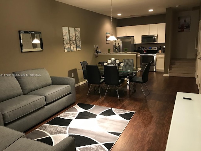 living room with dark hardwood / wood-style flooring