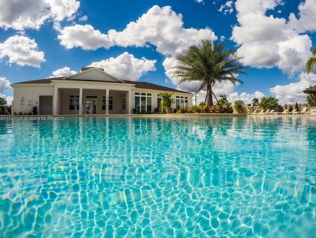 view of swimming pool featuring ceiling fan