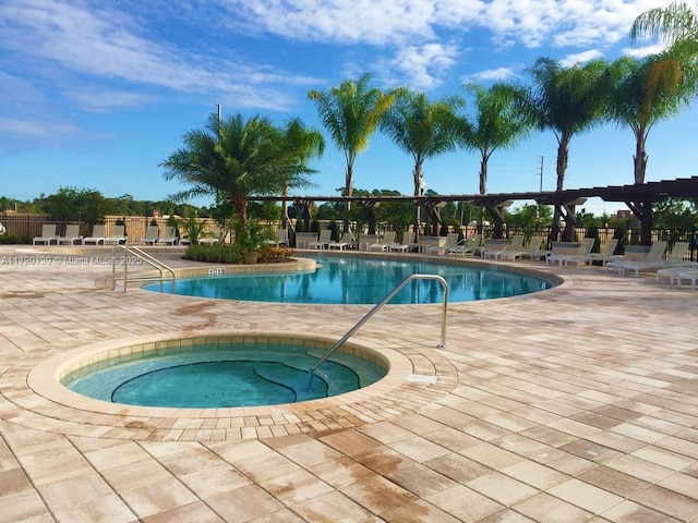 view of pool featuring a community hot tub, a patio, and a pergola