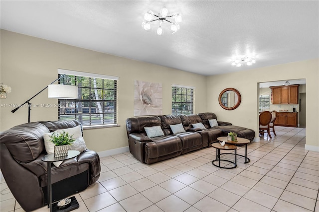 tiled living room featuring a notable chandelier