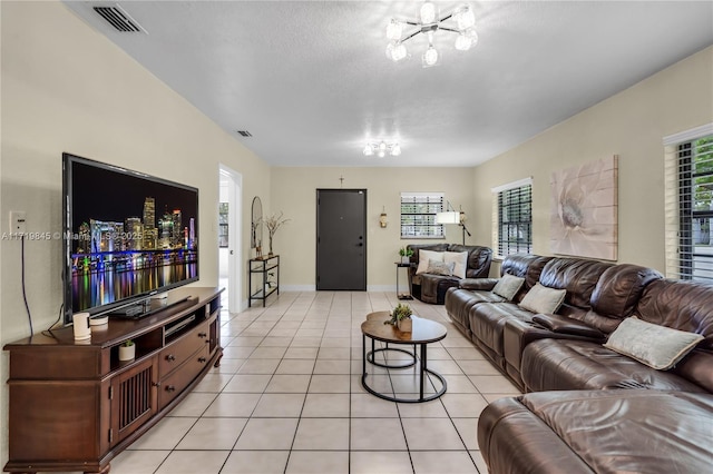 tiled living room with an inviting chandelier