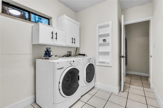 laundry area featuring light tile patterned flooring, built in shelves, cabinets, and washing machine and clothes dryer