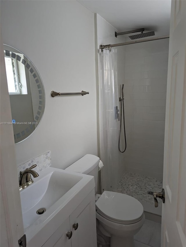 bathroom with a shower with curtain, vanity, toilet, and tile patterned floors