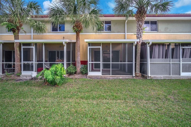 4923 SW 66th Ter Unit 4923, Davie, FL 33314 - rear view of house with stucco siding, a lawn, and a sunroom