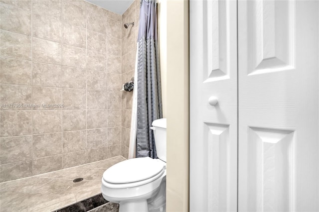 bathroom with toilet and walk in shower