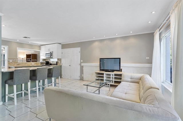 tiled living room with ornamental molding