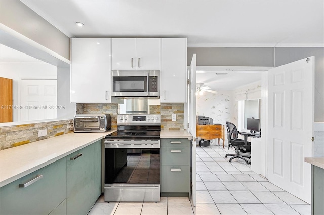 kitchen with white cabinets, stainless steel appliances, and light countertops