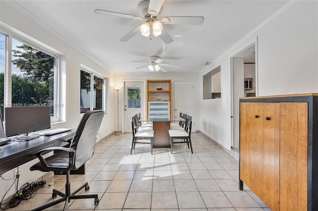 dining room featuring crown molding, baseboards, and light tile patterned floors