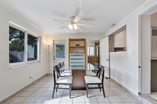 dining area featuring light tile patterned floors, visible vents, ornamental molding, ceiling fan, and baseboards