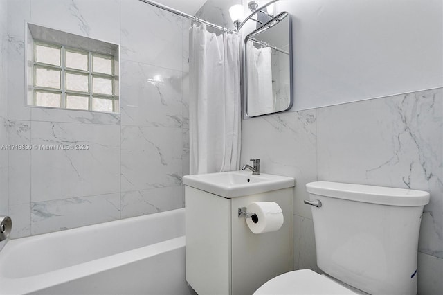 full bath featuring shower / bath combo, tile walls, vanity, and toilet