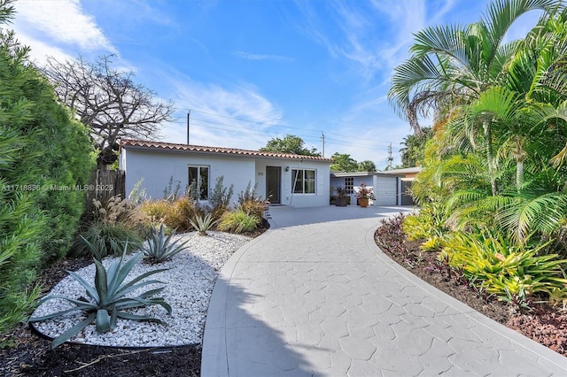 view of front of property with a tiled roof and stucco siding