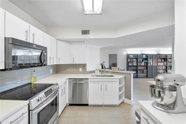 kitchen with white cabinets, sink, kitchen peninsula, and stainless steel appliances