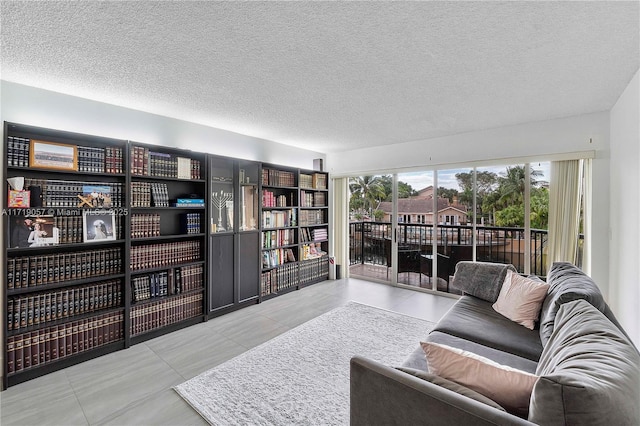 living room featuring light tile patterned floors and a textured ceiling