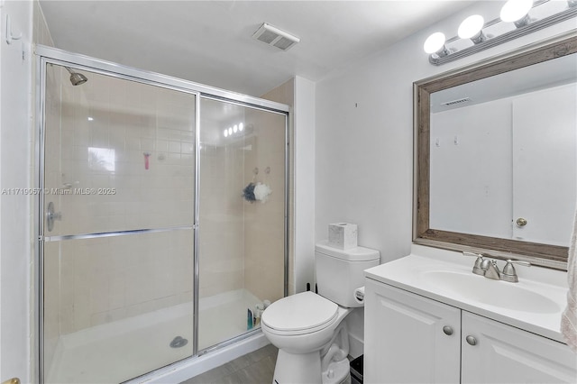 bathroom with vanity, an enclosed shower, and toilet