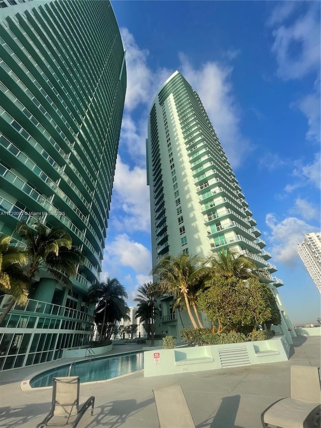 view of building exterior with a community pool