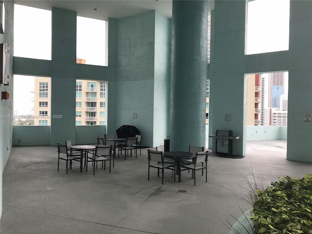 interior space with concrete flooring and a high ceiling