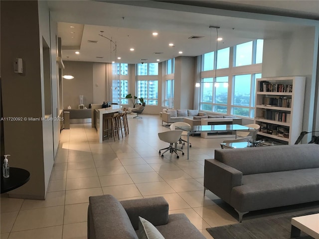 tiled living room with a wall of windows