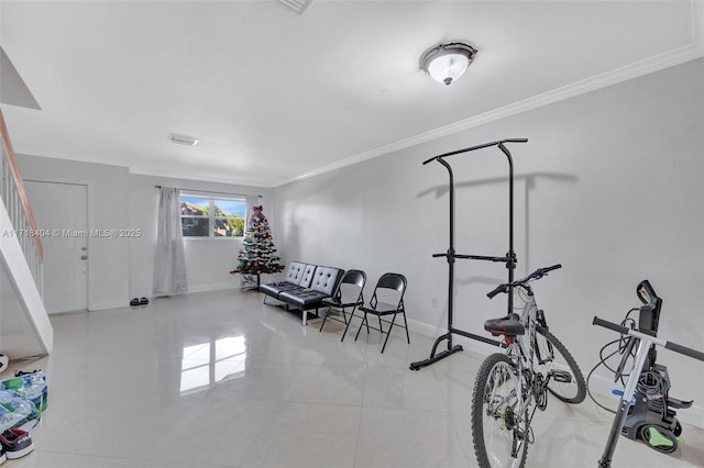 workout room with ornamental molding and light tile patterned flooring