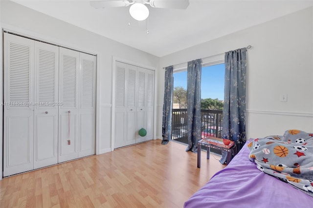 bedroom with two closets, ceiling fan, access to outside, and light wood-type flooring