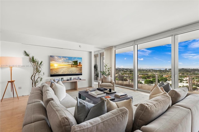 living room featuring light hardwood / wood-style flooring and a wall of windows