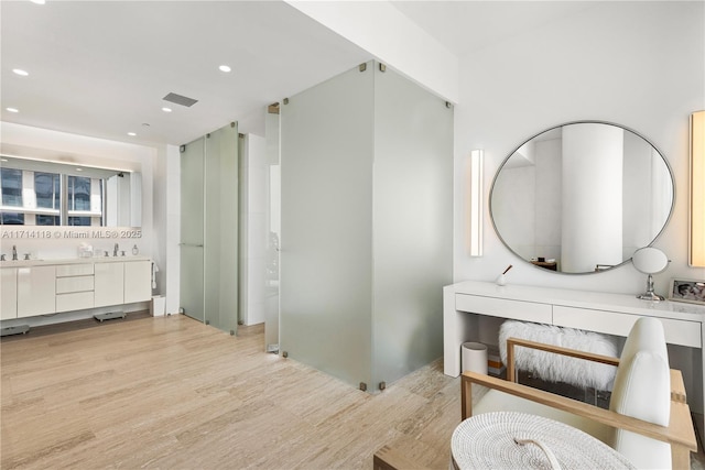 bathroom featuring hardwood / wood-style flooring and vanity