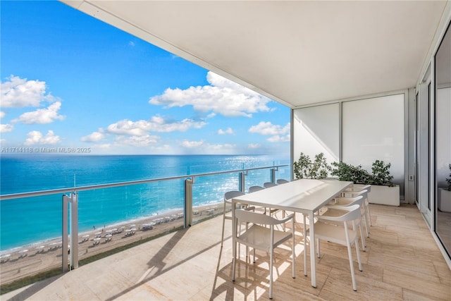 balcony with a beach view and a water view