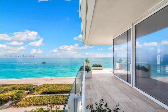 balcony with a water view and a beach view