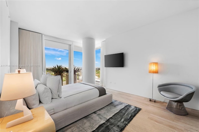 bedroom featuring light hardwood / wood-style floors and expansive windows