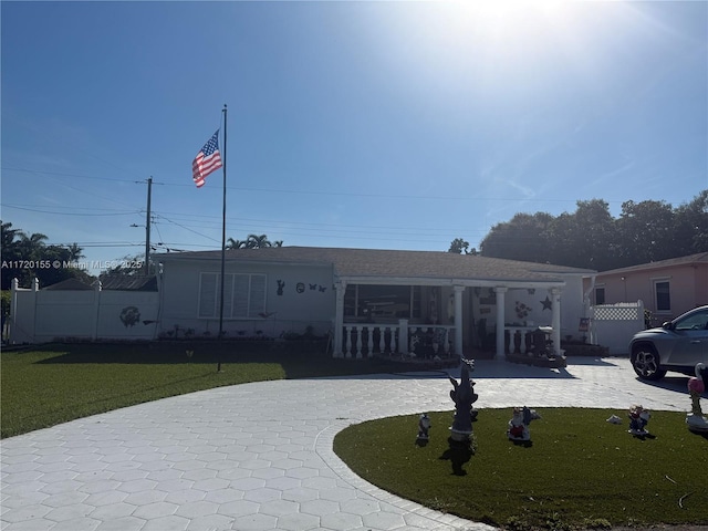 view of front of house with a front yard and covered porch