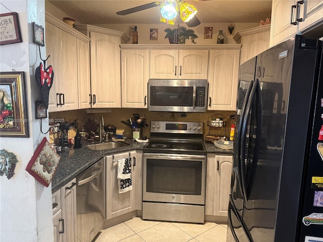 kitchen featuring ceiling fan, sink, a textured ceiling, light tile patterned floors, and appliances with stainless steel finishes