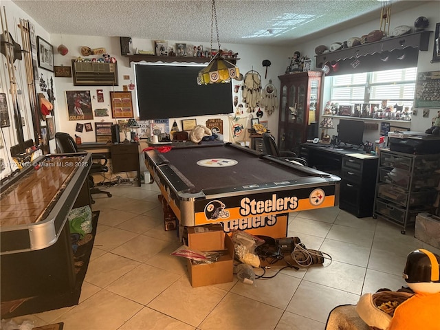 recreation room featuring light tile patterned flooring, a textured ceiling, and billiards