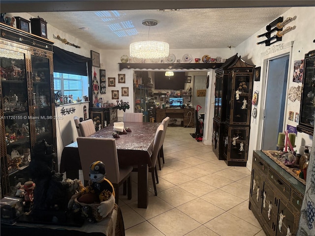 dining space featuring light tile patterned flooring, a textured ceiling, and an inviting chandelier