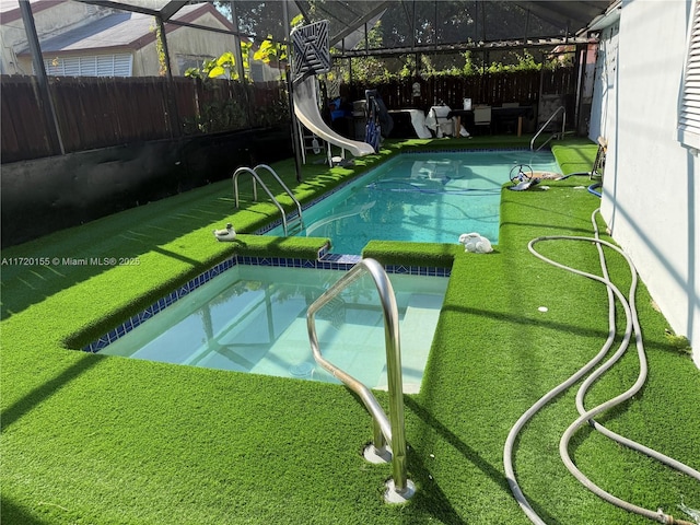 view of swimming pool with a water slide