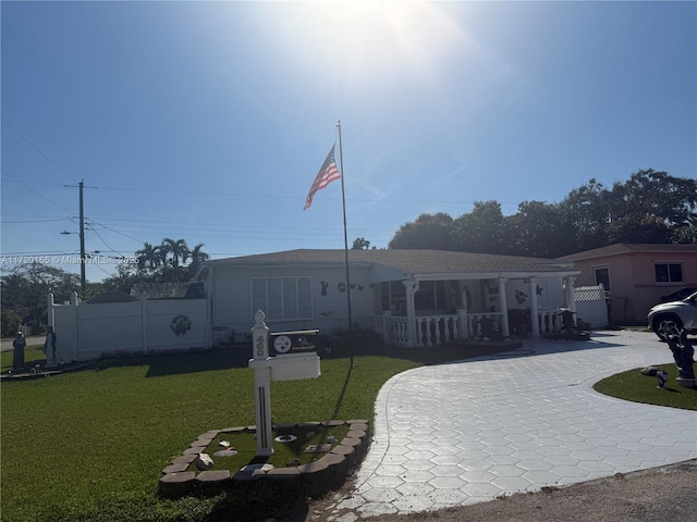 exterior space featuring covered porch and a front lawn